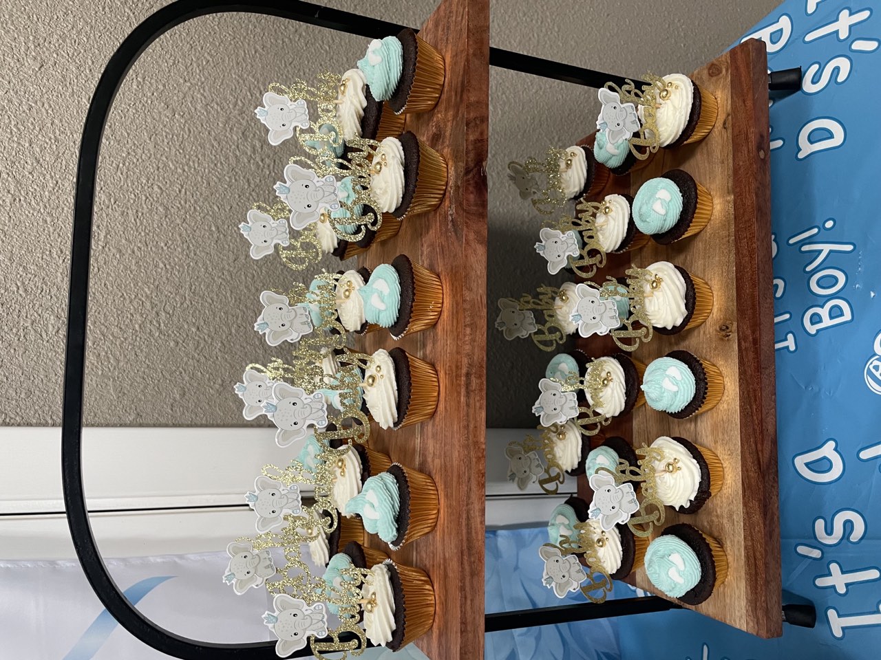 Baby shower cupcake display with blue and white buttercream