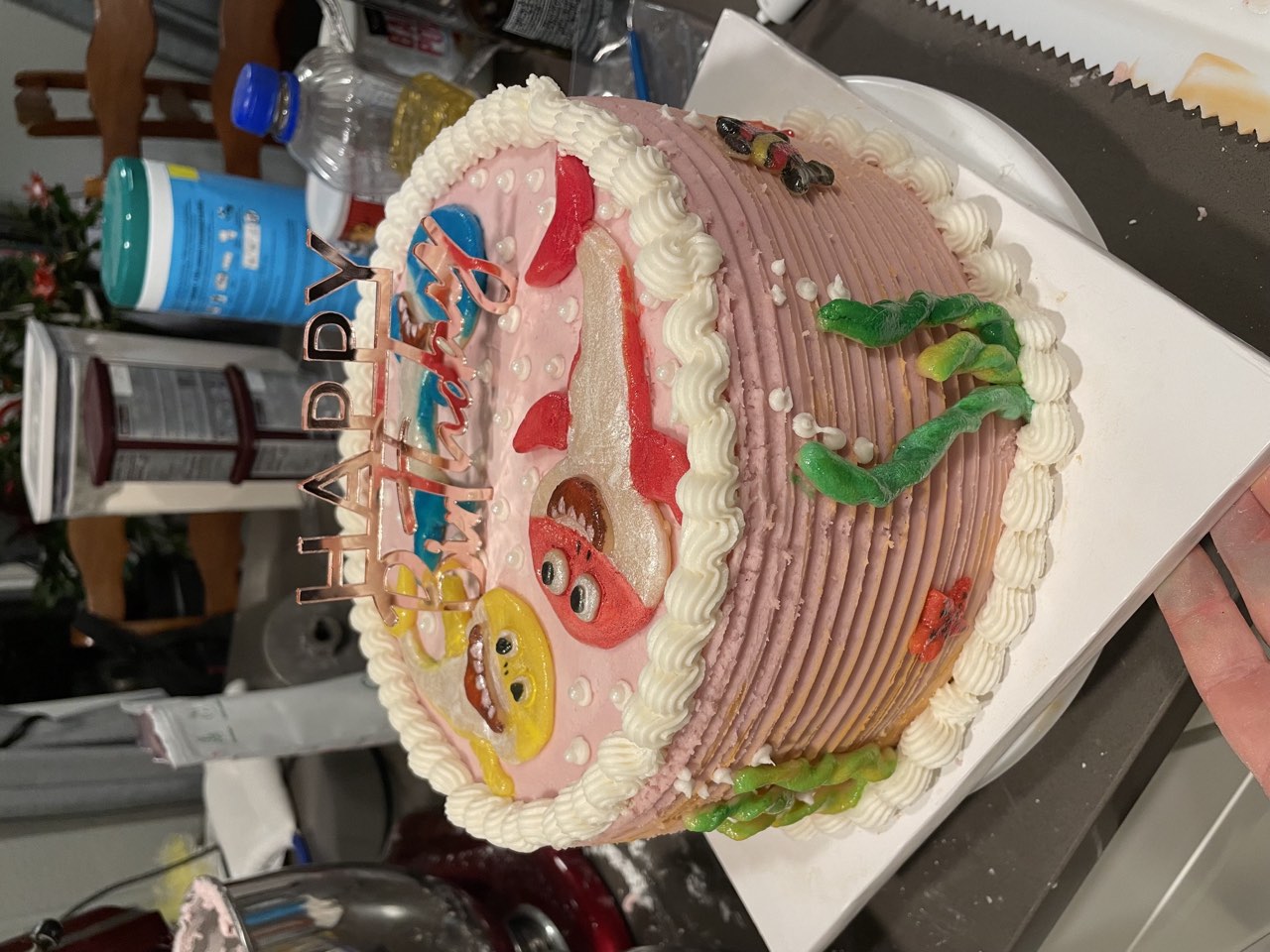 Pink ocean themed birthday cake with piped buttercream and birthday topper