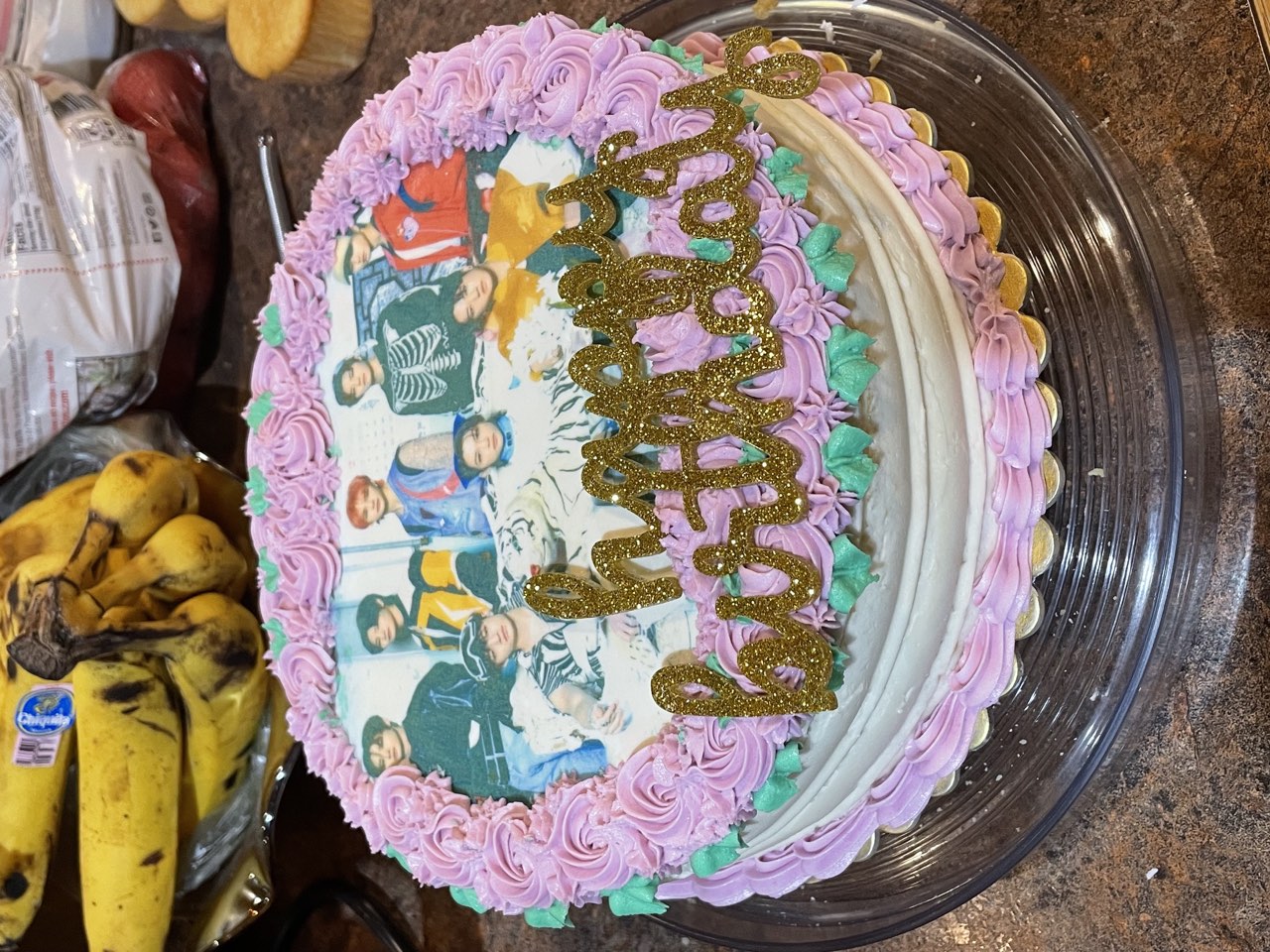 Pink birthday cake with edible photo design and gold birthday topper