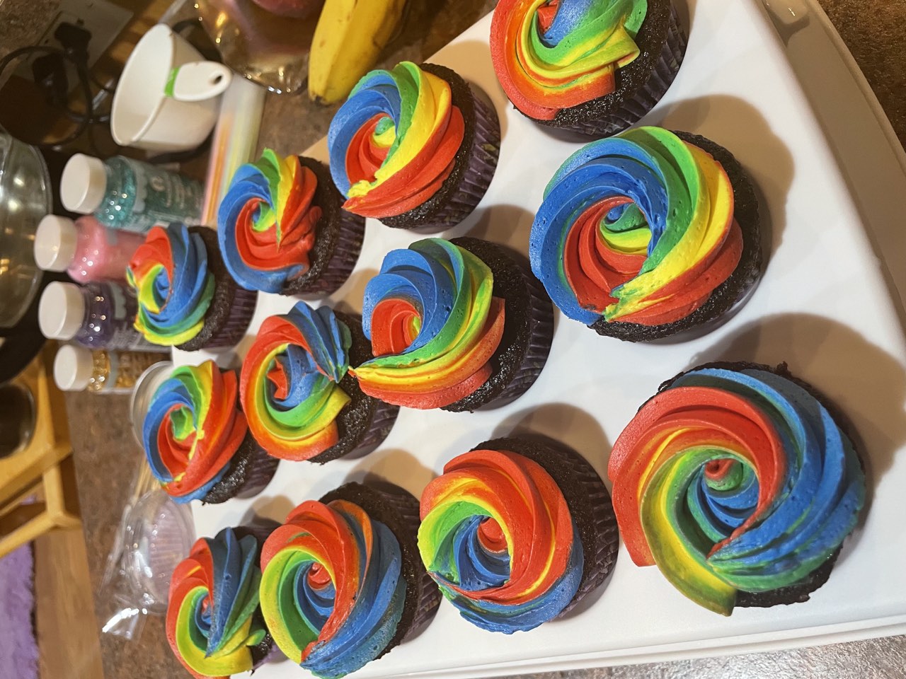Chocolate cupcakes with rainbow buttercream swirls